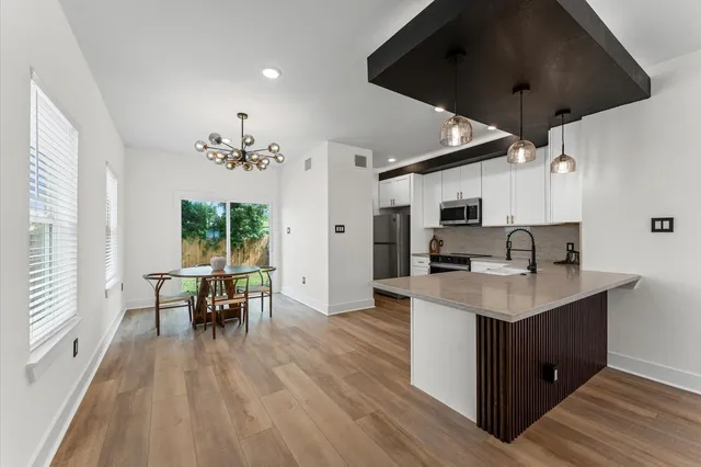 a kitchen with furniture and wooden floor