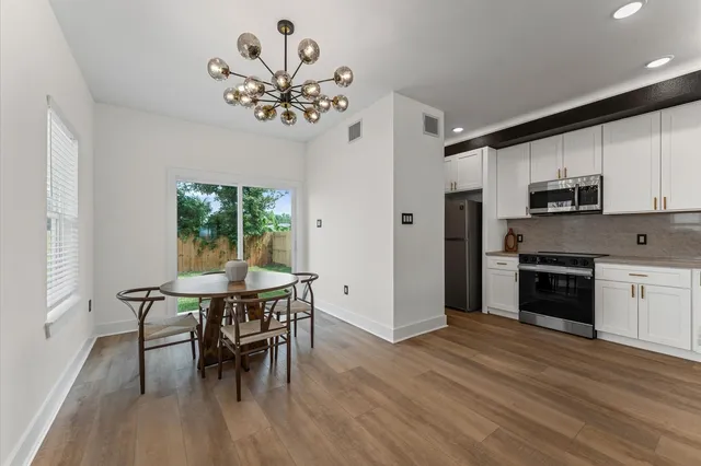 a view of a dining room with furniture window and wooden floor