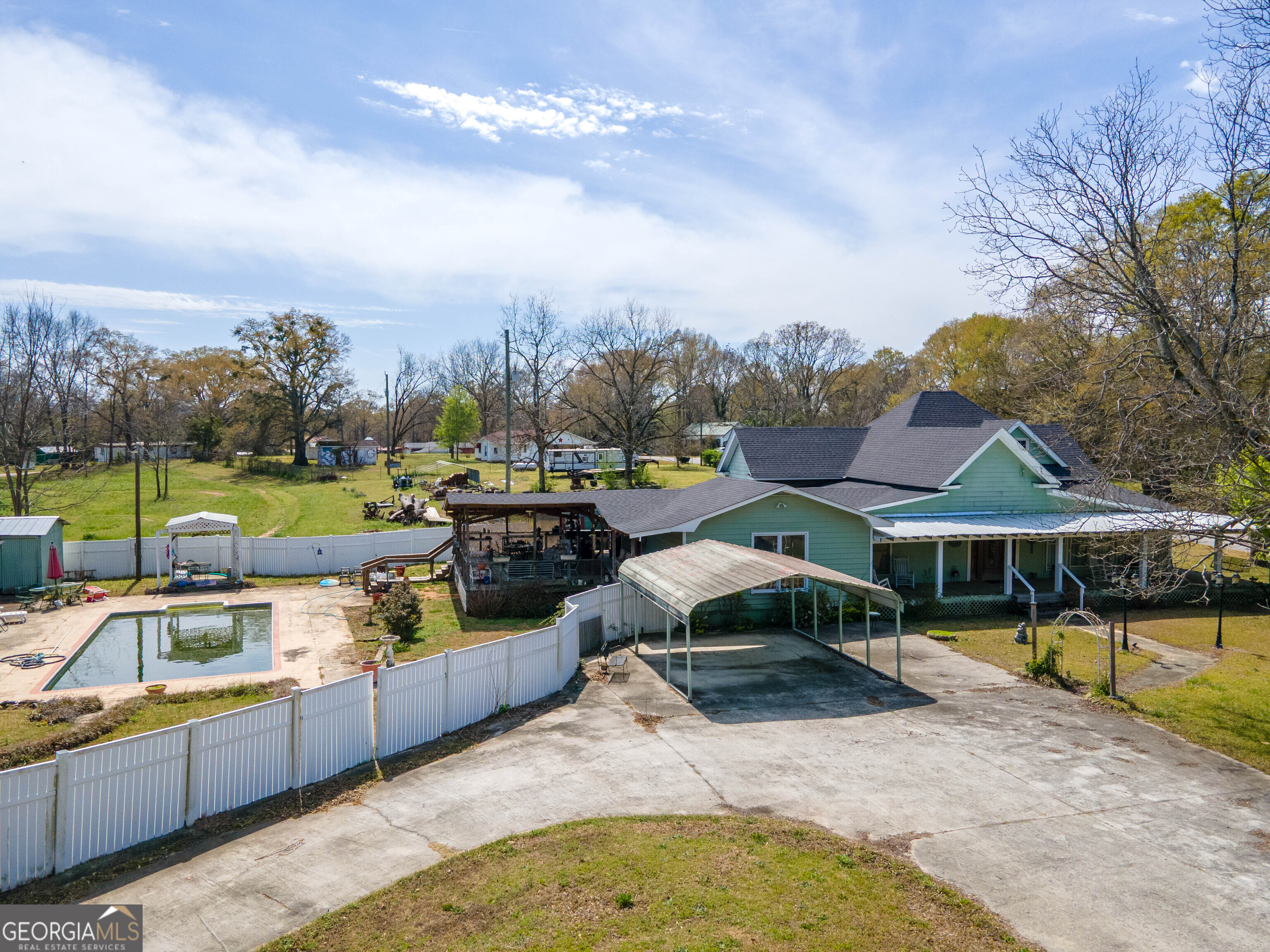 a view of a swimming pool and lounge chairs in the patio