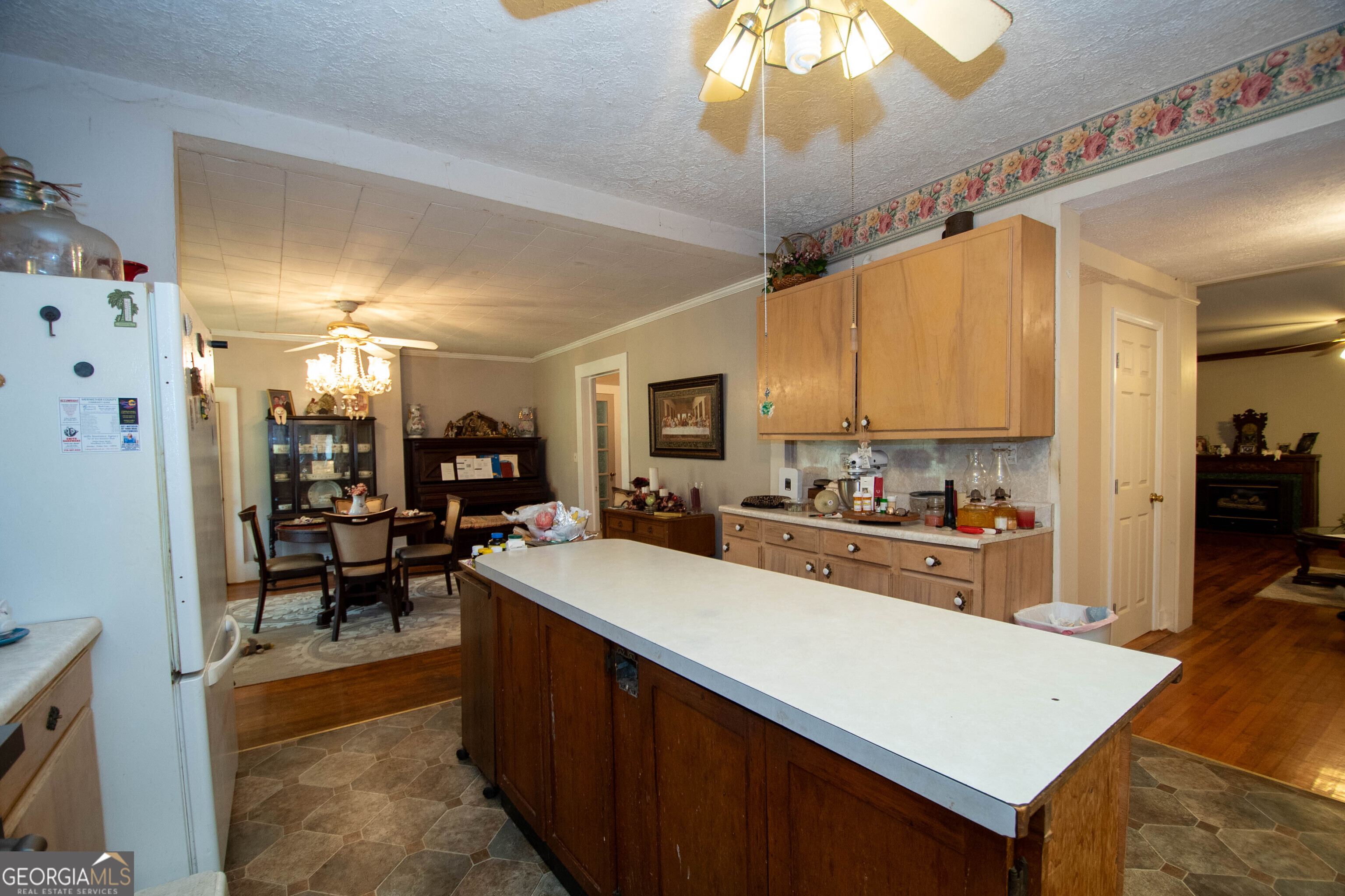 125 Fowler Street Warm Springs, GA 31830 - Photo 14 of 46 a kitchen with a stove a refrigerator and a dining table