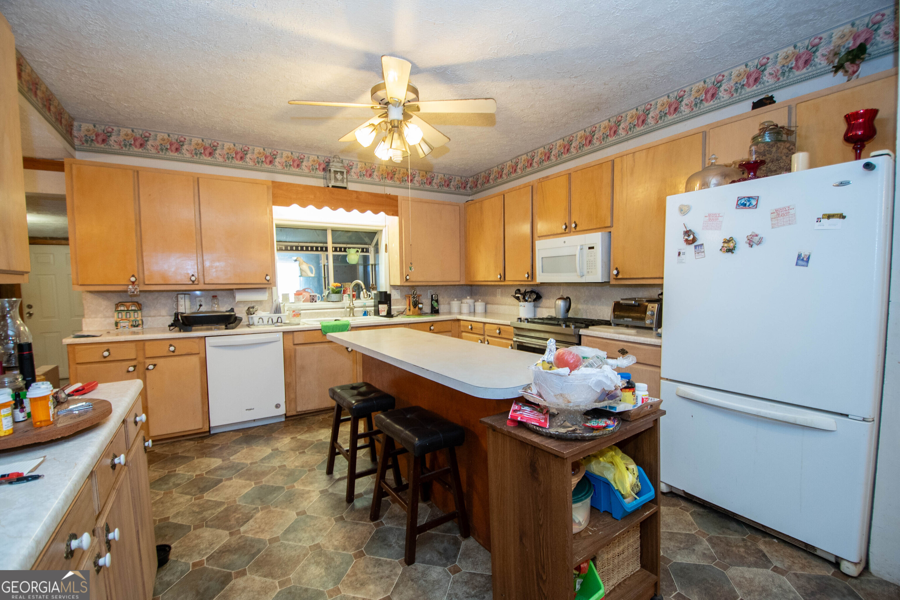 125 Fowler Street Warm Springs, GA 31830 - Photo 16 of 46 a kitchen with refrigerator and window