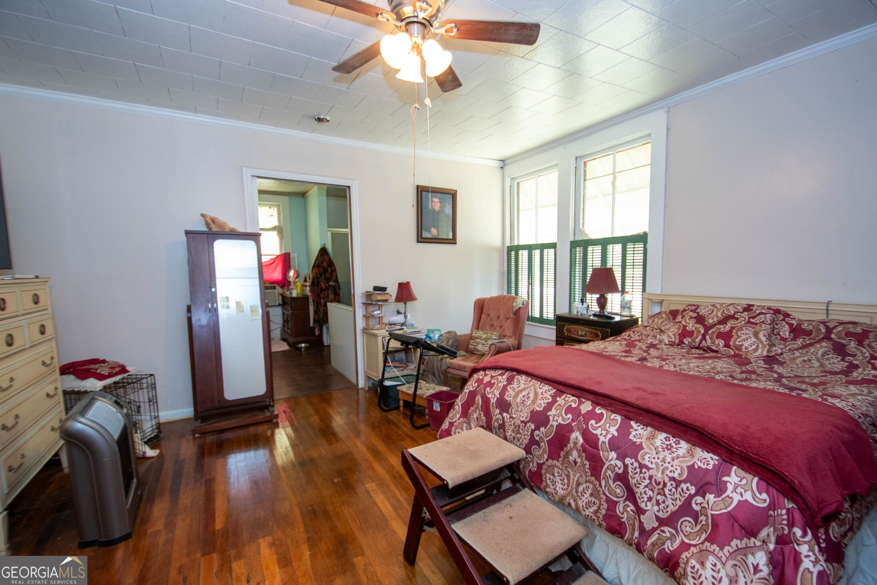 125 Fowler Street Warm Springs, GA 31830 - Photo 17 of 46 a bedroom with a bed and wooden floor