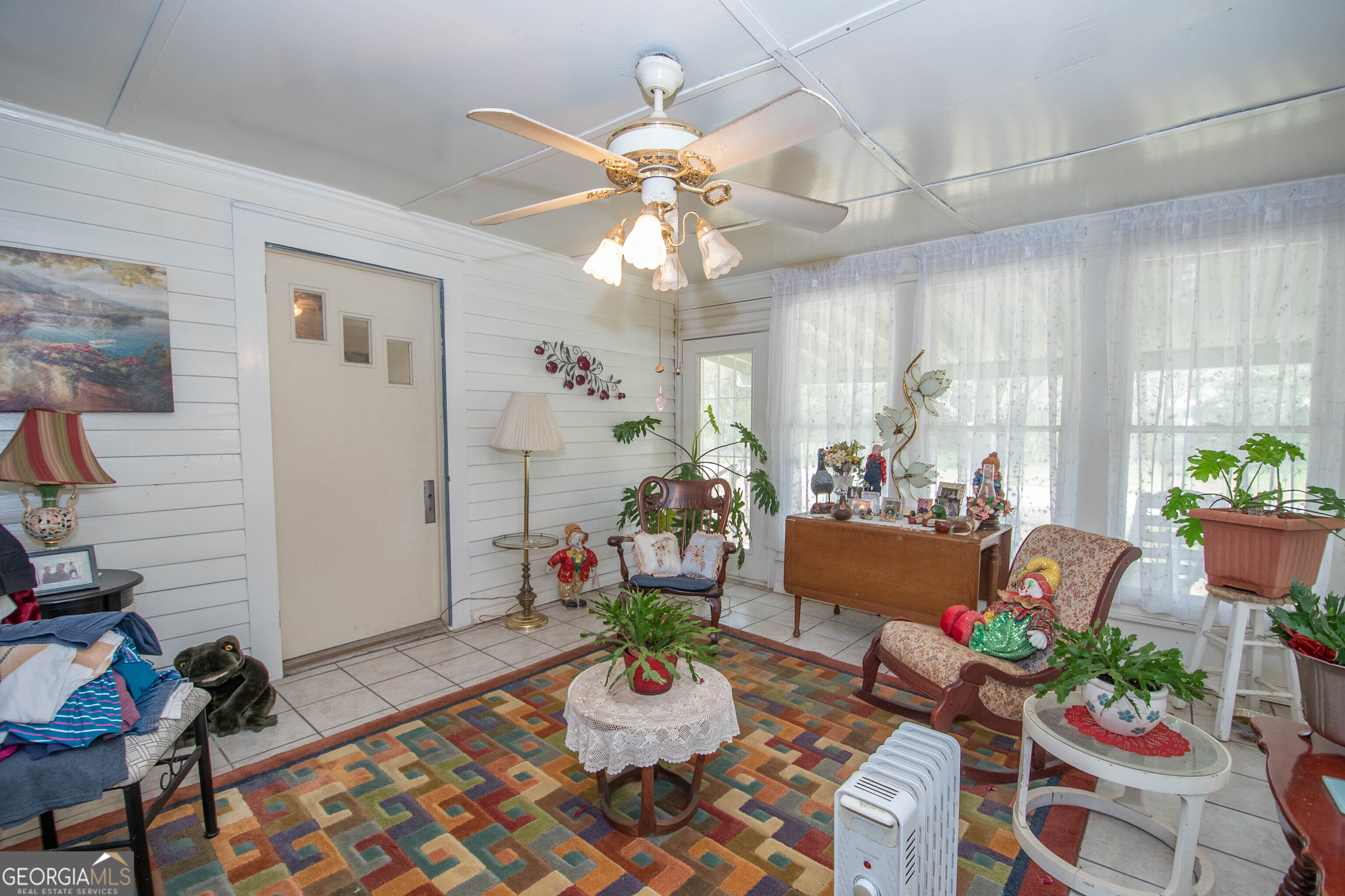 125 Fowler Street Warm Springs, GA 31830 - Photo 24 of 46 a living room with furniture and a chandelier
