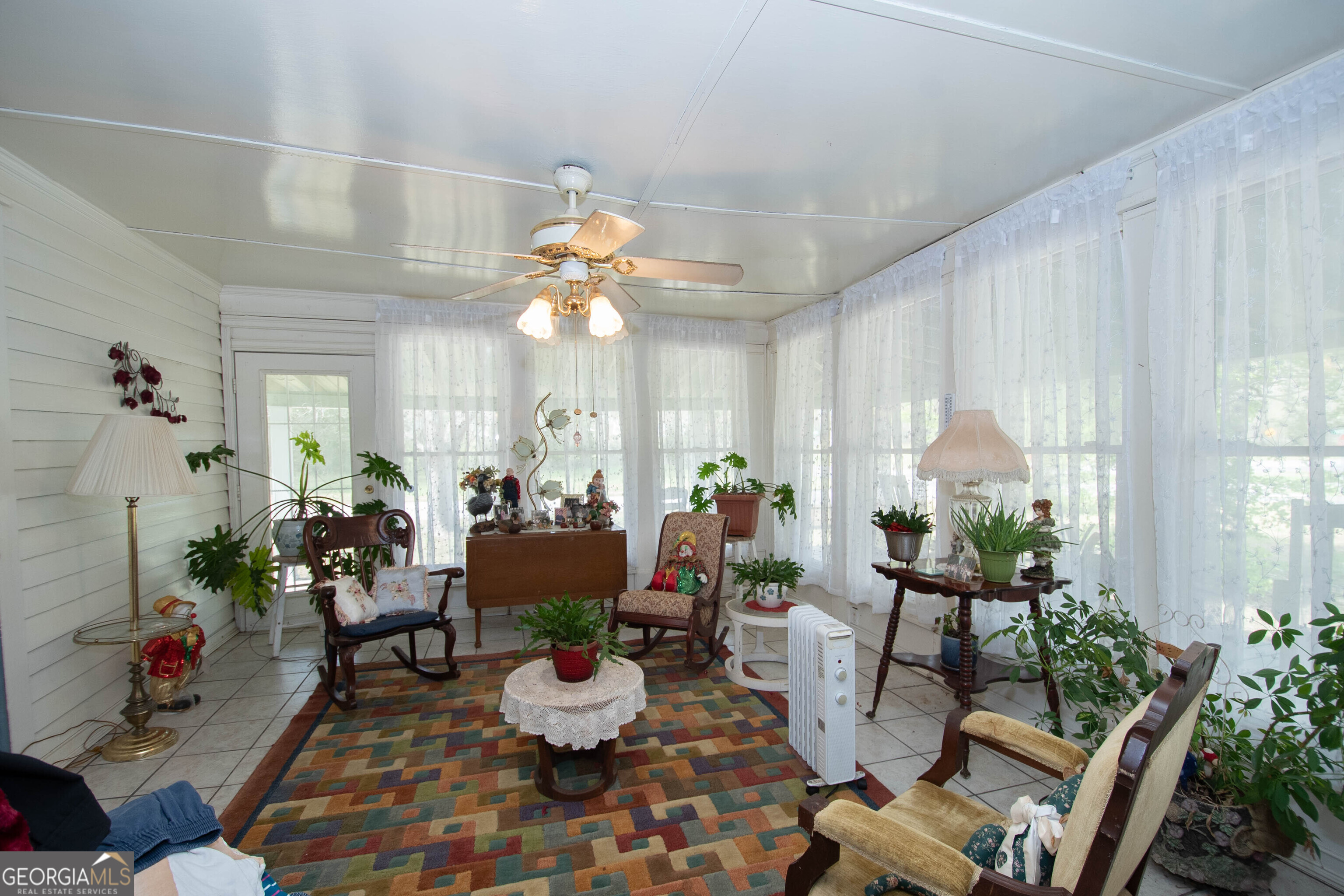125 Fowler Street Warm Springs, GA 31830 - Photo 25 of 46 a living room with furniture and a chandelier