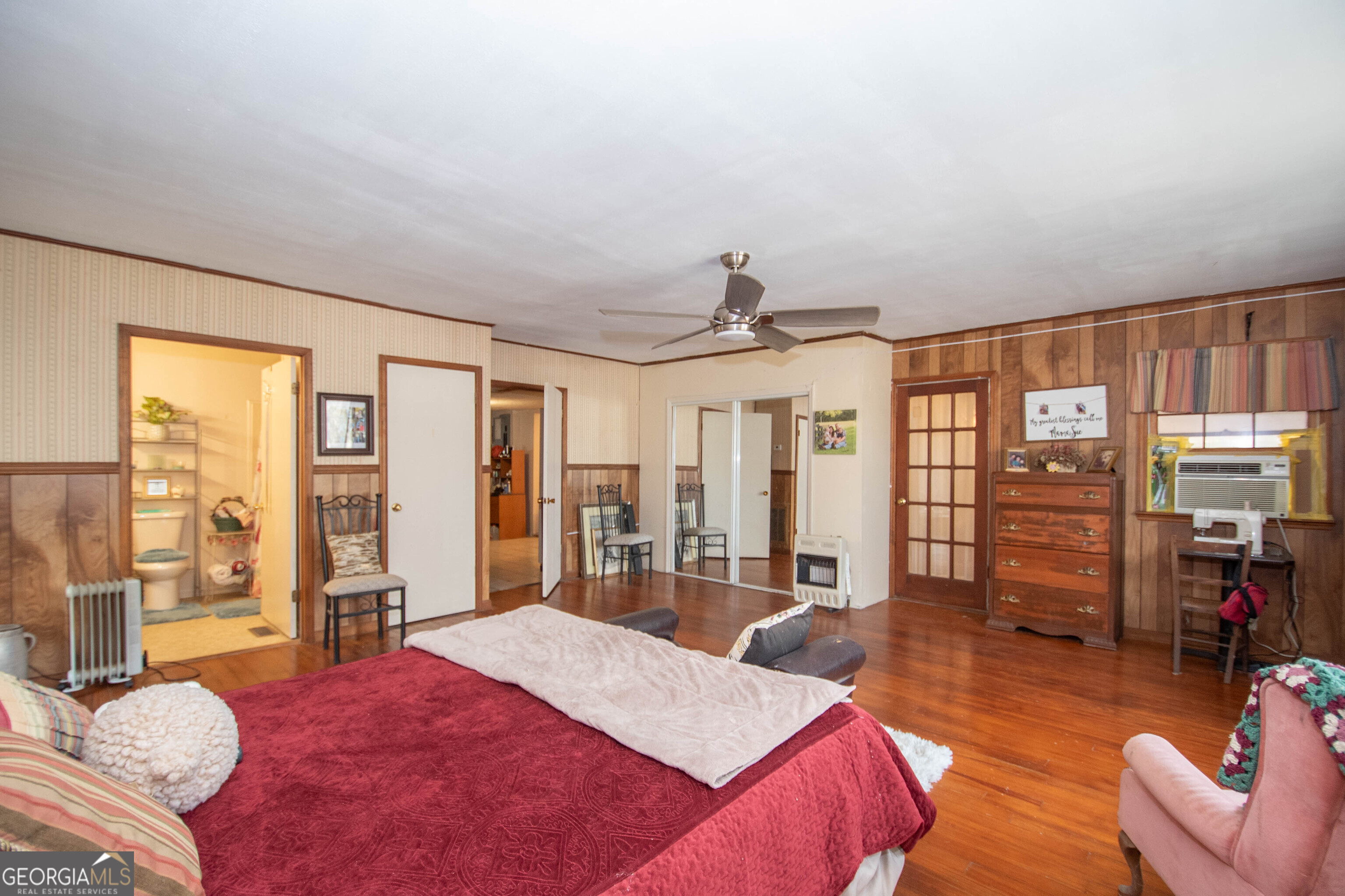 125 Fowler Street Warm Springs, GA 31830 - Photo 27 of 46 a spacious bedroom with a large bed and a large window