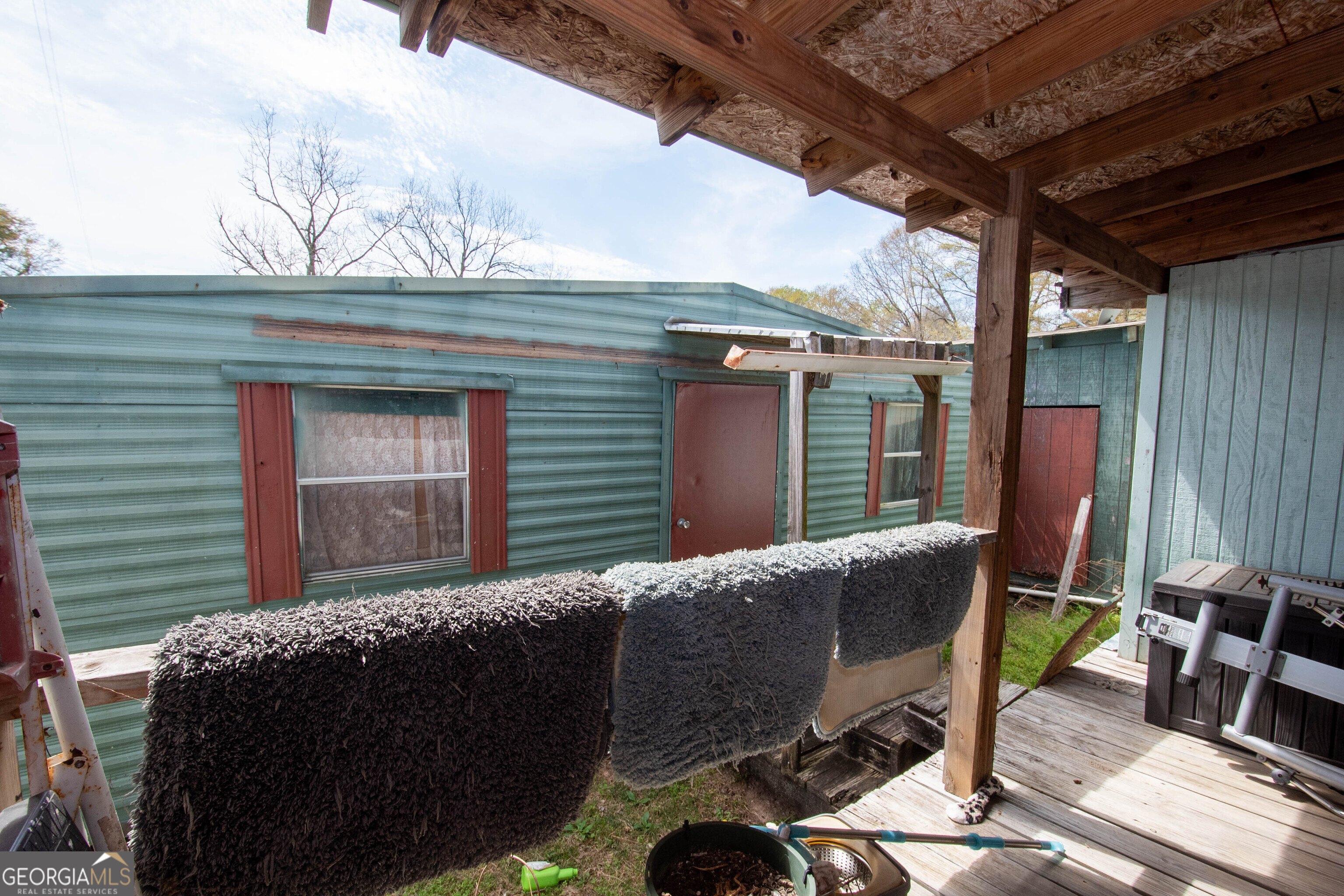 125 Fowler Street Warm Springs, GA 31830 - Photo 35 of 46 a view of a patio with table and chairs with wooden fence