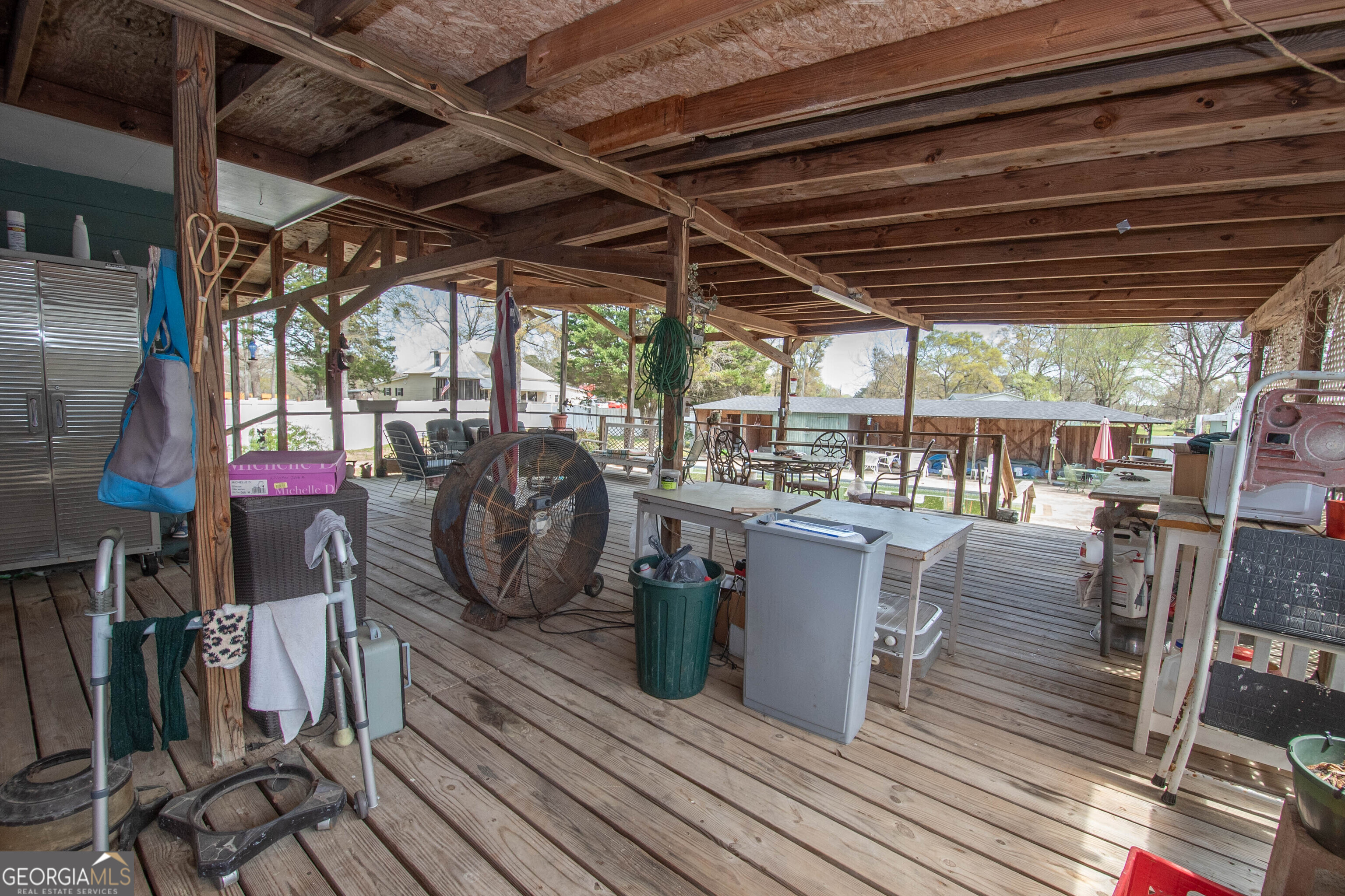 125 Fowler Street Warm Springs, GA 31830 - Photo 36 of 46 a view of a patio with table and chairs barbeque with wooden floor