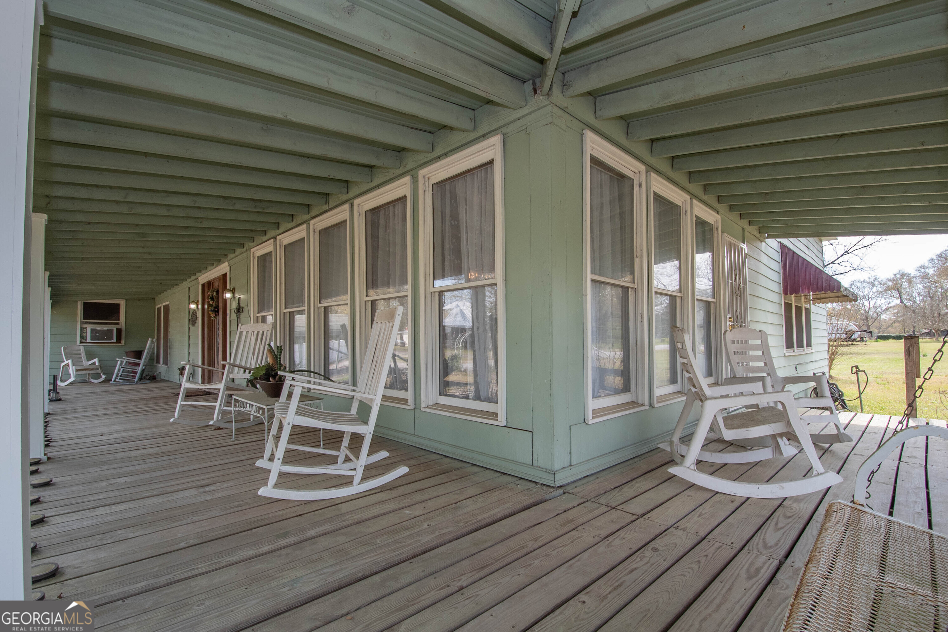 125 Fowler Street Warm Springs, GA 31830 - Photo 6 of 46 a view of a patio with table and chairs and wooden floor