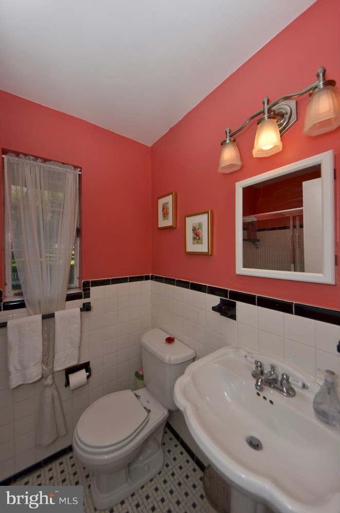 3020 Military Road Arlington, VA 22207 - Photo 13 of 26 a bathroom with a sink a toilet and mirror