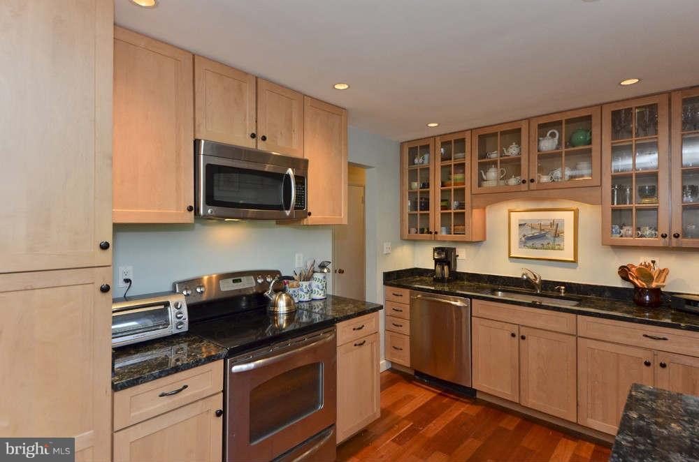 3020 Military Road Arlington, VA 22207 - Photo 7 of 26 a kitchen with granite countertop a sink a stove and cabinets