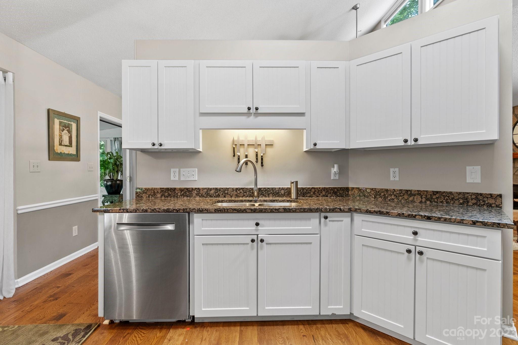 6 Holly Ridge Court Arden, NC 28704 - Photo 11 of 27 a kitchen with granite countertop white cabinets and a stainless steel appliances