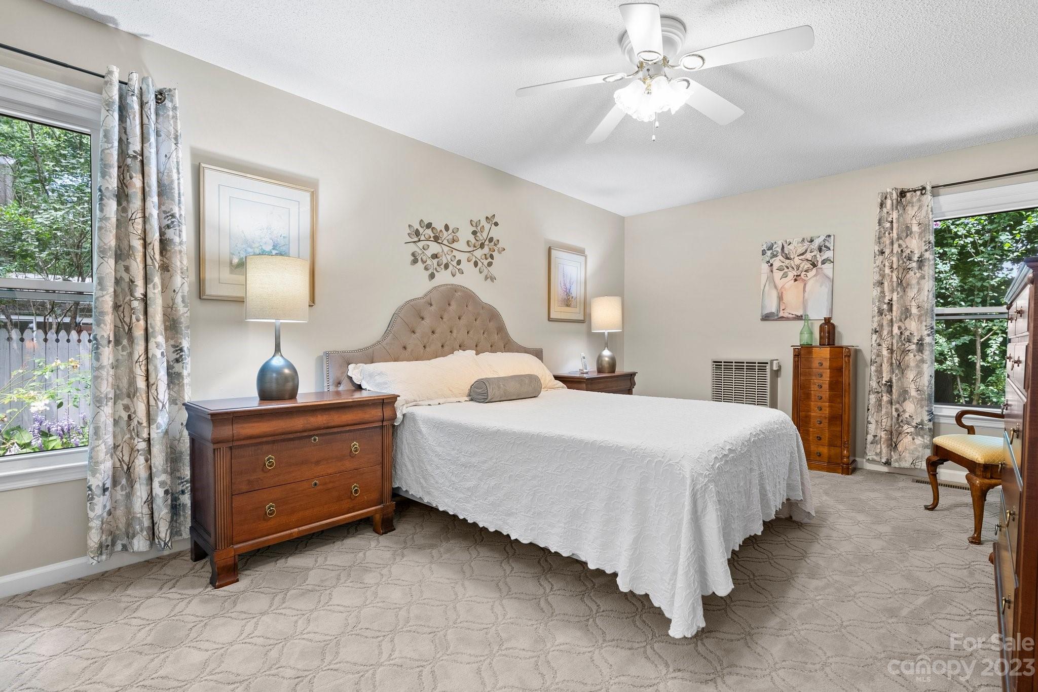6 Holly Ridge Court Arden, NC 28704 - Photo 13 of 27 a bed room with a bed and a chandelier