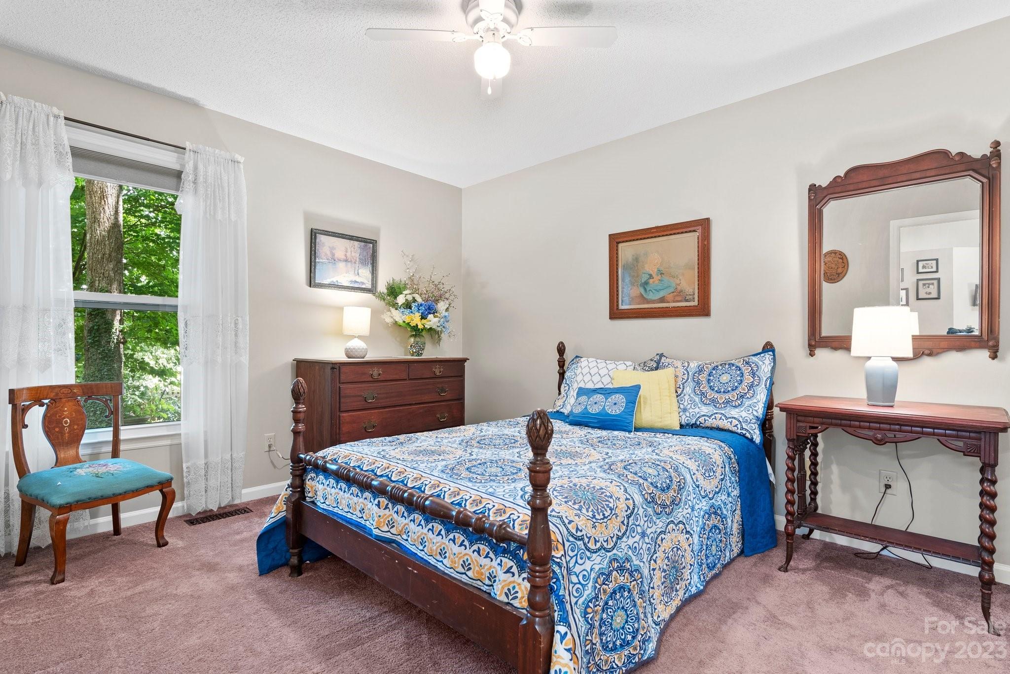 6 Holly Ridge Court Arden, NC 28704 - Photo 15 of 27 a bedroom with a bed and a table