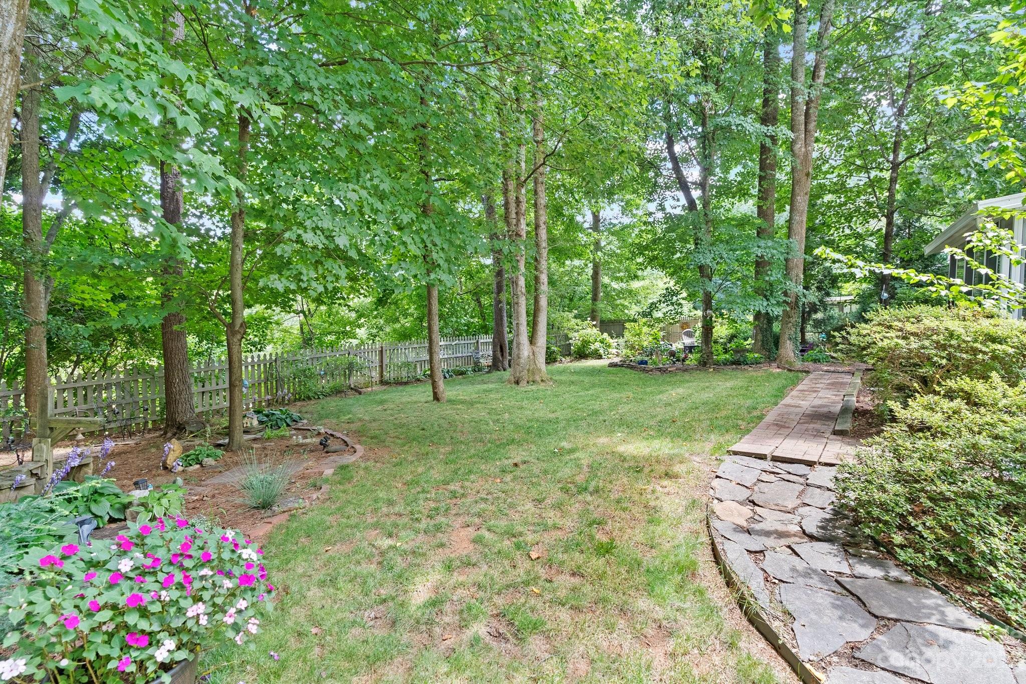 6 Holly Ridge Court Arden, NC 28704 - Photo 24 of 27 a view of a garden with flowers and trees