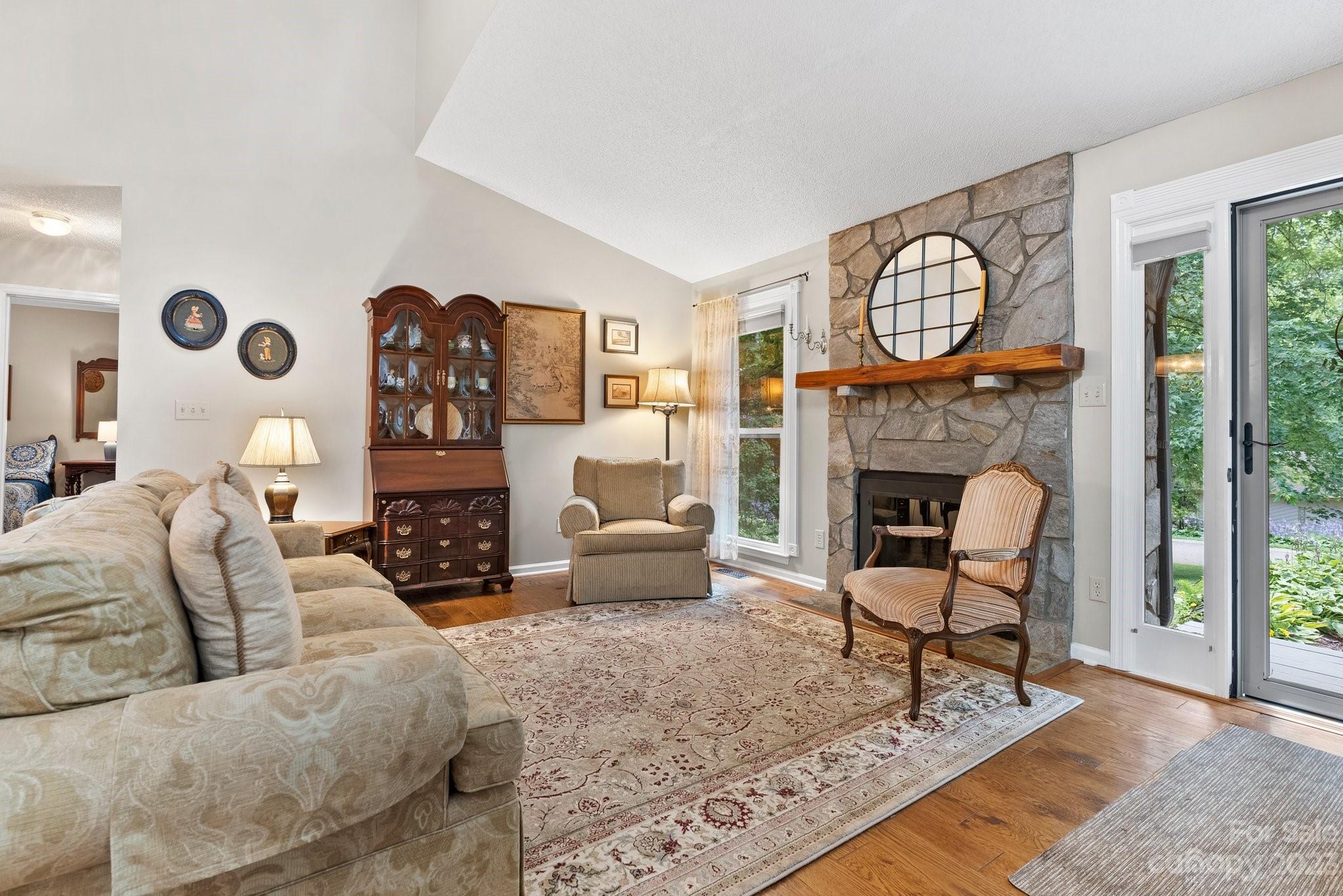 6 Holly Ridge Court Arden, NC 28704 - Photo 4 of 27 a living room with furniture a rug and a fireplace