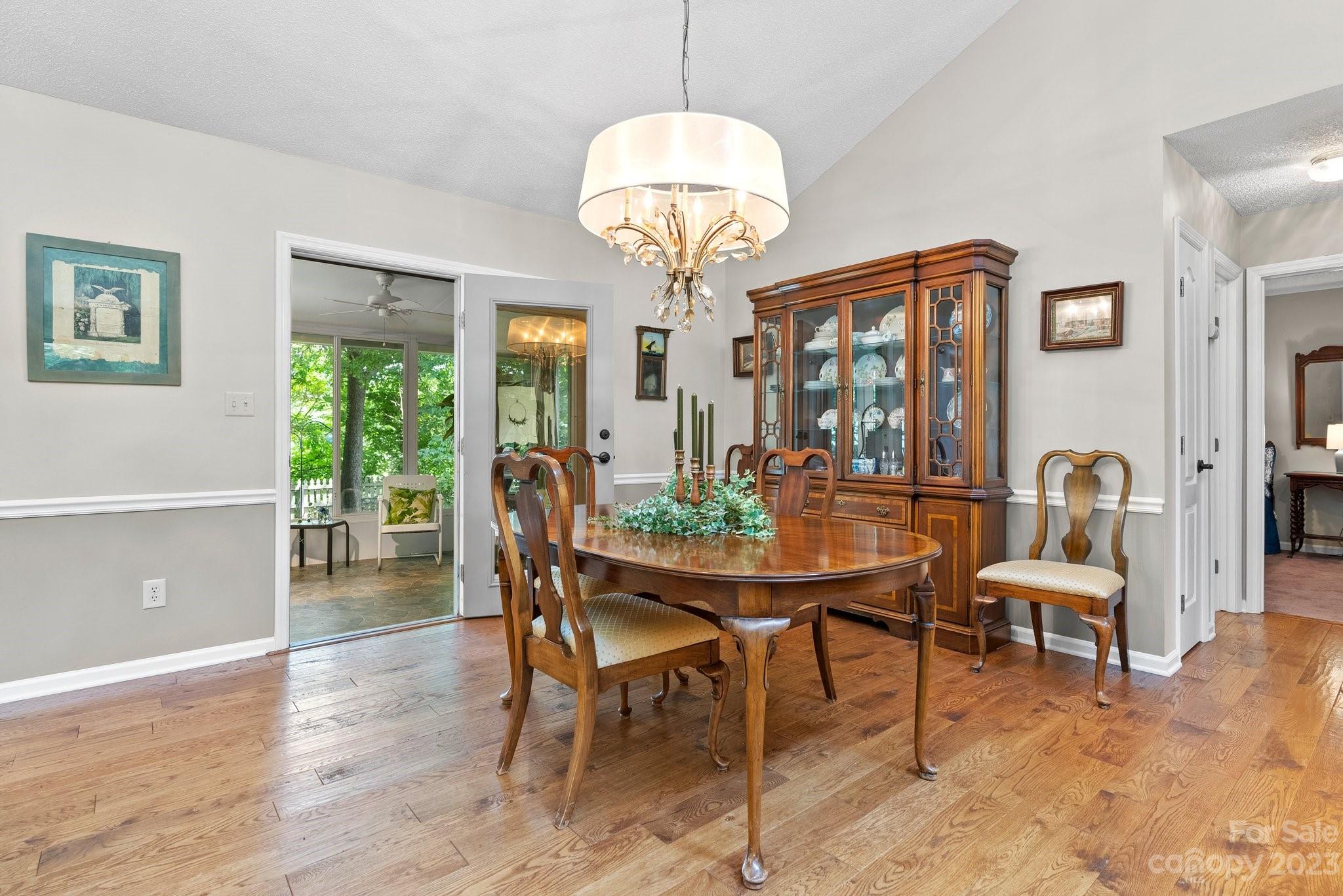 6 Holly Ridge Court Arden, NC 28704 - Photo 6 of 27 a view of a dining room with furniture wooden floor and chandelier
