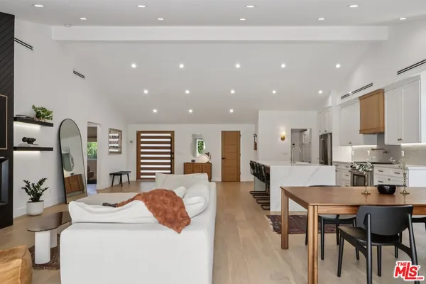 a large kitchen with a table and chairs in it