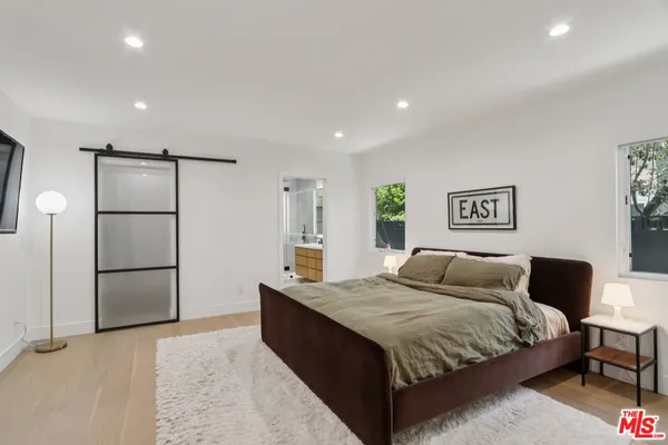 a bedroom with a large bed and a couch