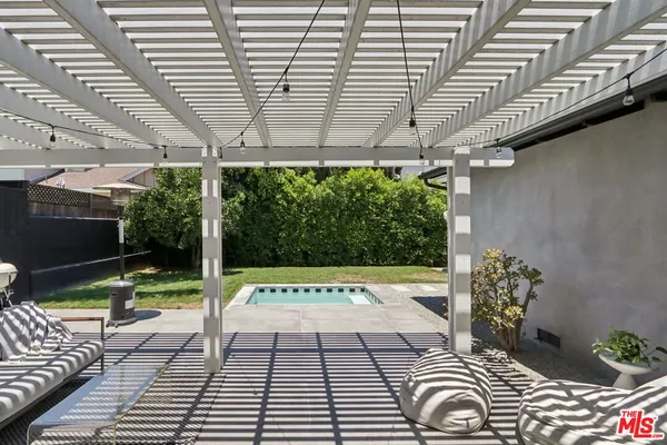 a view of a porch with furniture and garden