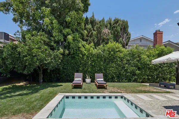 a view of backyard with sitting space