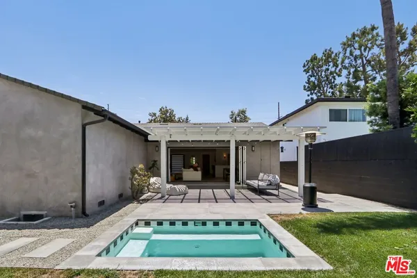 a view of a house with backyard porch and sitting area