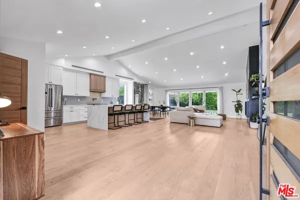 a view of living room with furniture and a fireplace