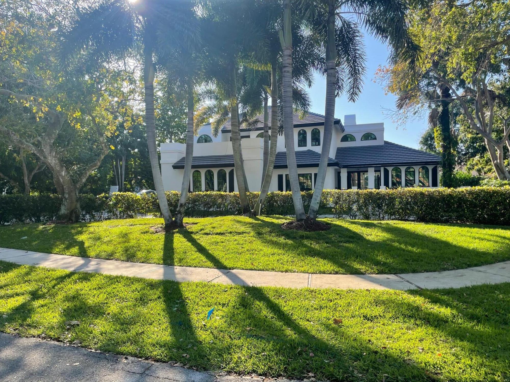 a view of an house with swimming pool and a yard