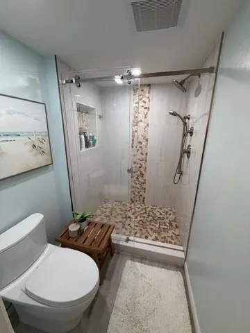 a bathroom with a sink a toilet and a mirror