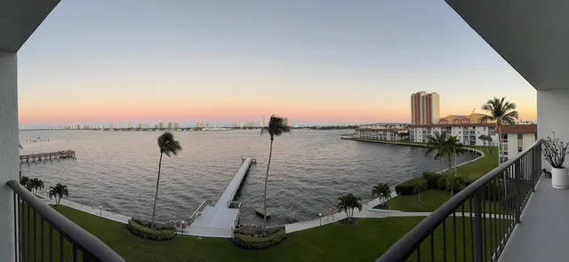 a view of balcony with wooden floor and lake view
