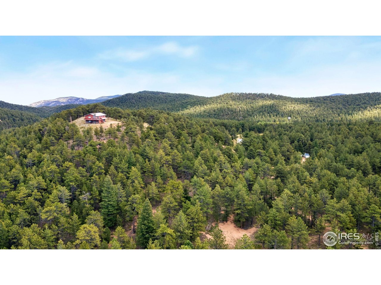 357 Big John Road Lyons, CO 80540 - Photo 2 of 14 a open area with mountains in the background