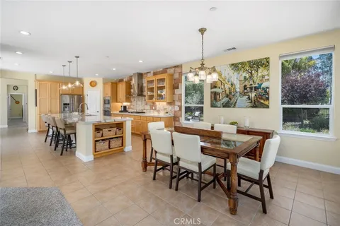 a dining hall with stainless steel appliances granite countertop a stove and a refrigerator