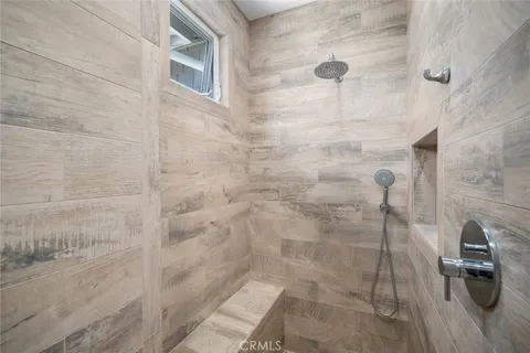 a bedroom with a bed lamp closet and window