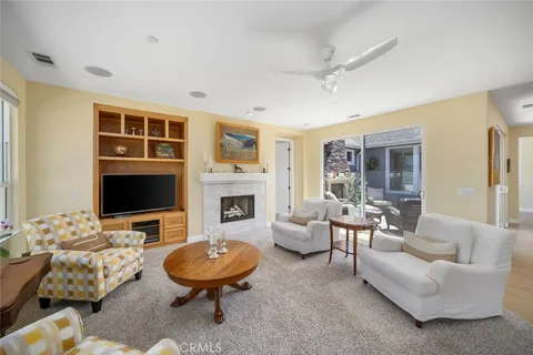 a living room with furniture flat screen tv and a fireplace