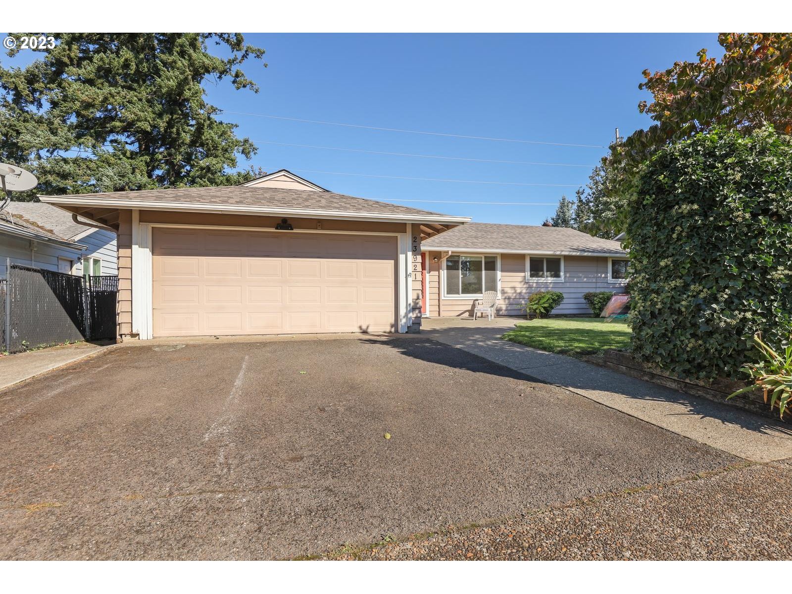 23921 Southeast Oak Street Gresham, OR 97030 - Photo 22 of 46 a front view of a house with a yard and garage