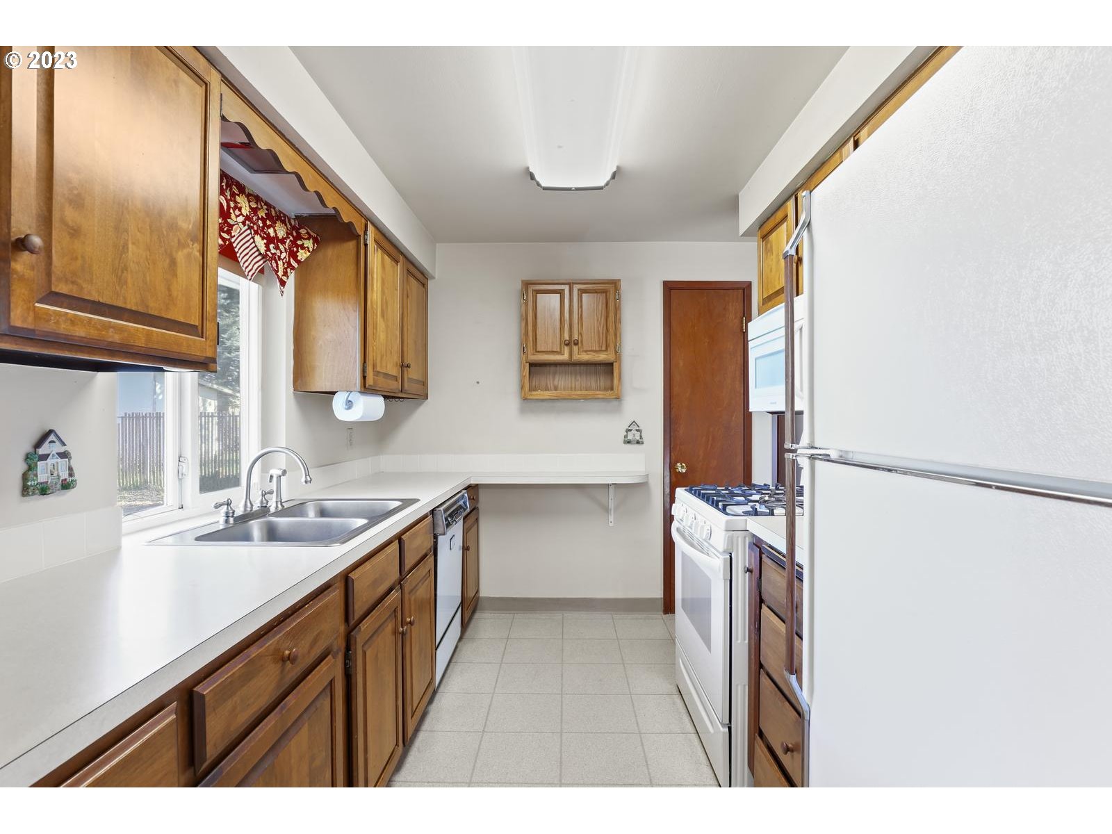 23921 Southeast Oak Street Gresham, OR 97030 - Photo 31 of 46 a kitchen with a sink and a refrigerator