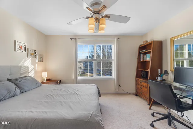 a bedroom with a large bed and a window