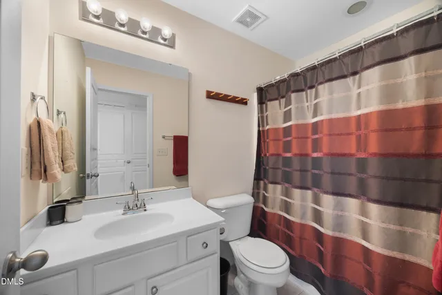 a view of a chairs and fire pit in the backyard of a house