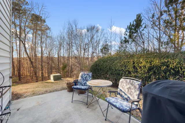 a view of a patio with table and chairs and potted plants