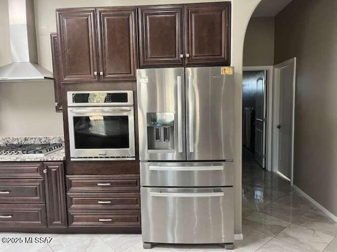 11553 East Tanque Verde Road Tucson, AZ 85749 - Photo 11 of 16 a kitchen with stainless steel appliances granite countertop a refrigerator and a stove top oven