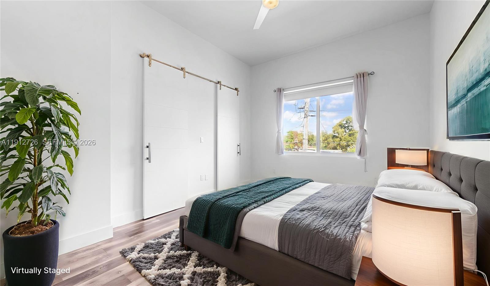 3461 Southwest 25th Street, Unit A Miami, FL 33133 - Photo 15 of 27 a bedroom with a bed and a potted plant