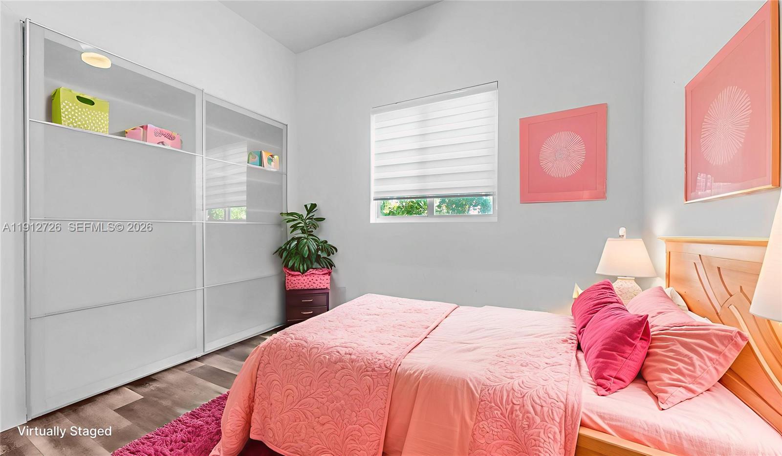 3461 Southwest 25th Street, Unit A Miami, FL 33133 - Photo 17 of 27 a bedroom with a bed and a potted plant