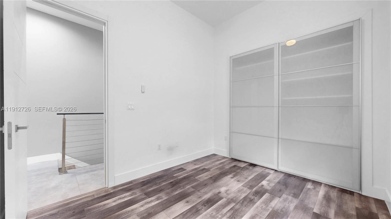 3461 Southwest 25th Street, Unit A Miami, FL 33133 - Photo 18 of 27 a view of empty room with wooden floor