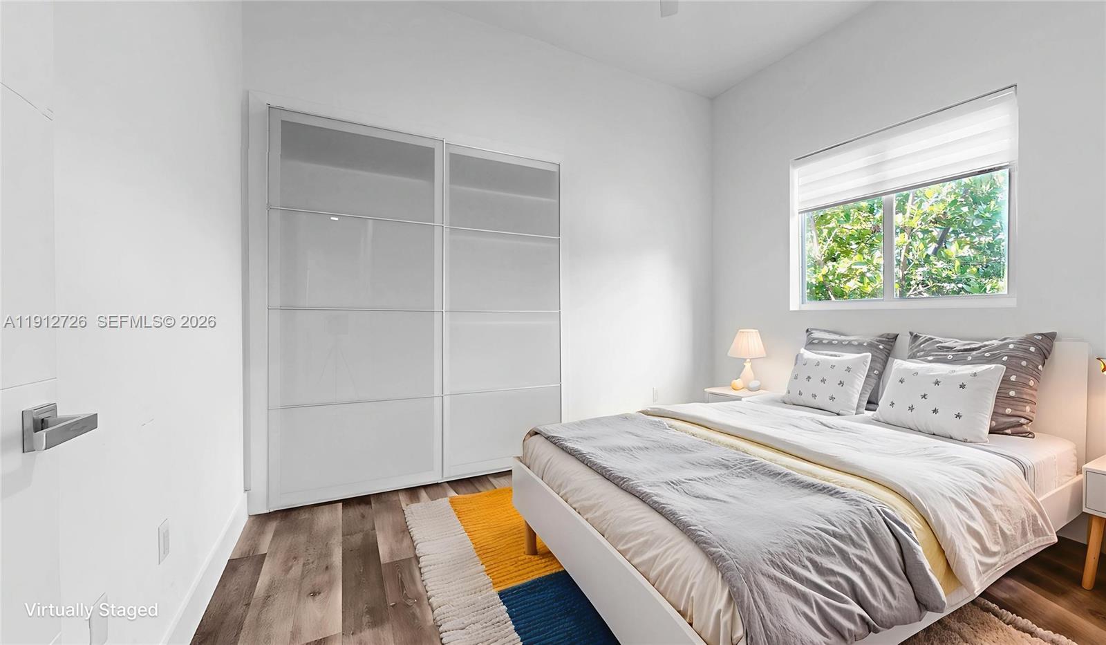 3461 Southwest 25th Street, Unit A Miami, FL 33133 - Photo 19 of 27 a bedroom with a bed and a window