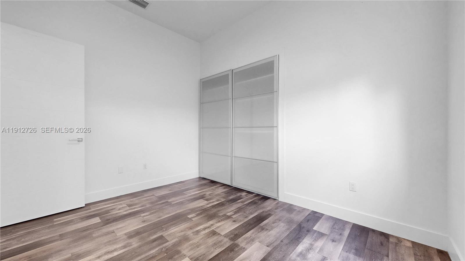 3461 Southwest 25th Street, Unit A Miami, FL 33133 - Photo 20 of 27 a view of empty room with wooden floor