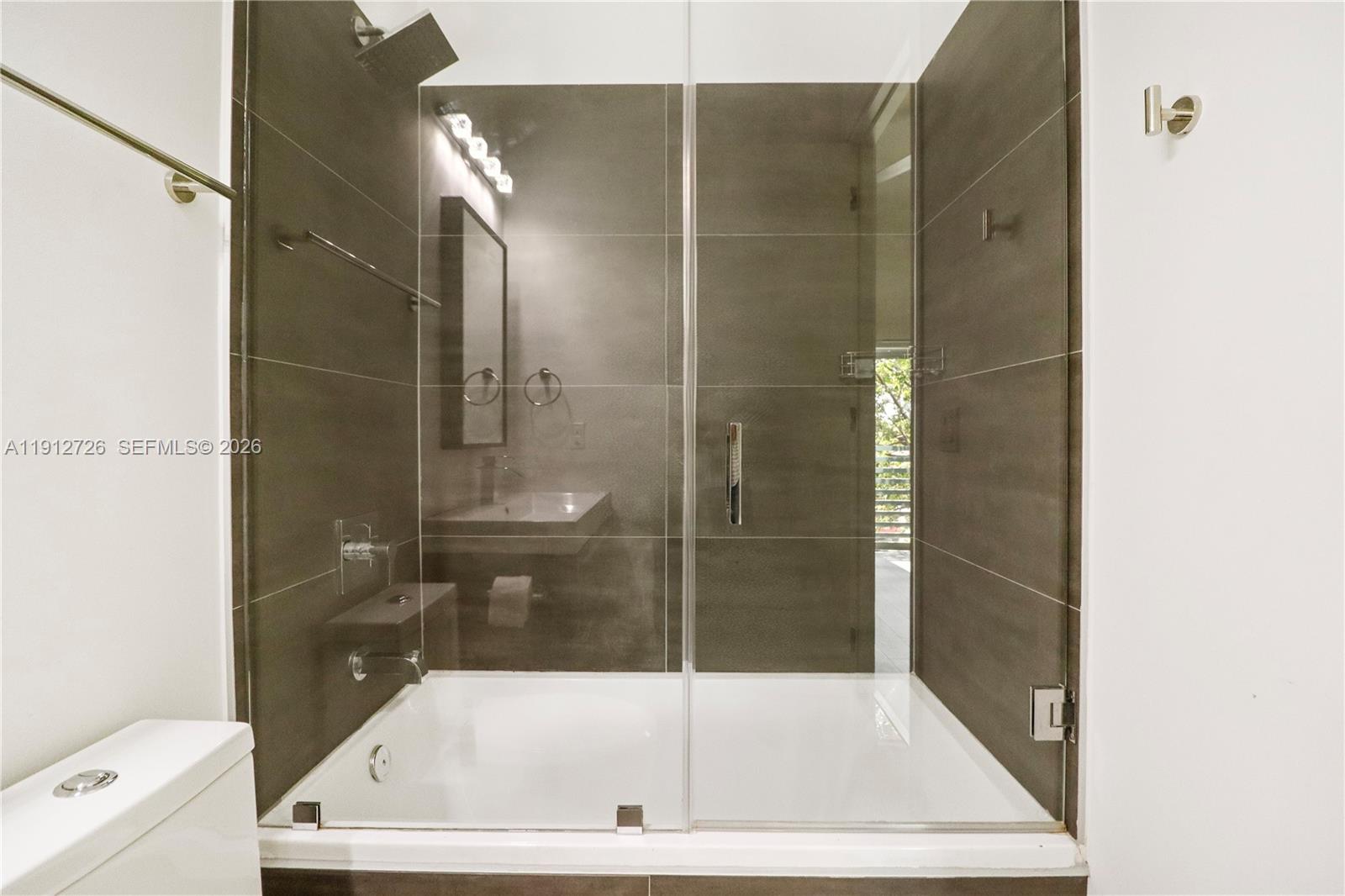 3461 Southwest 25th Street, Unit A Miami, FL 33133 - Photo 22 of 27 a bathroom with a bathtub and a shower