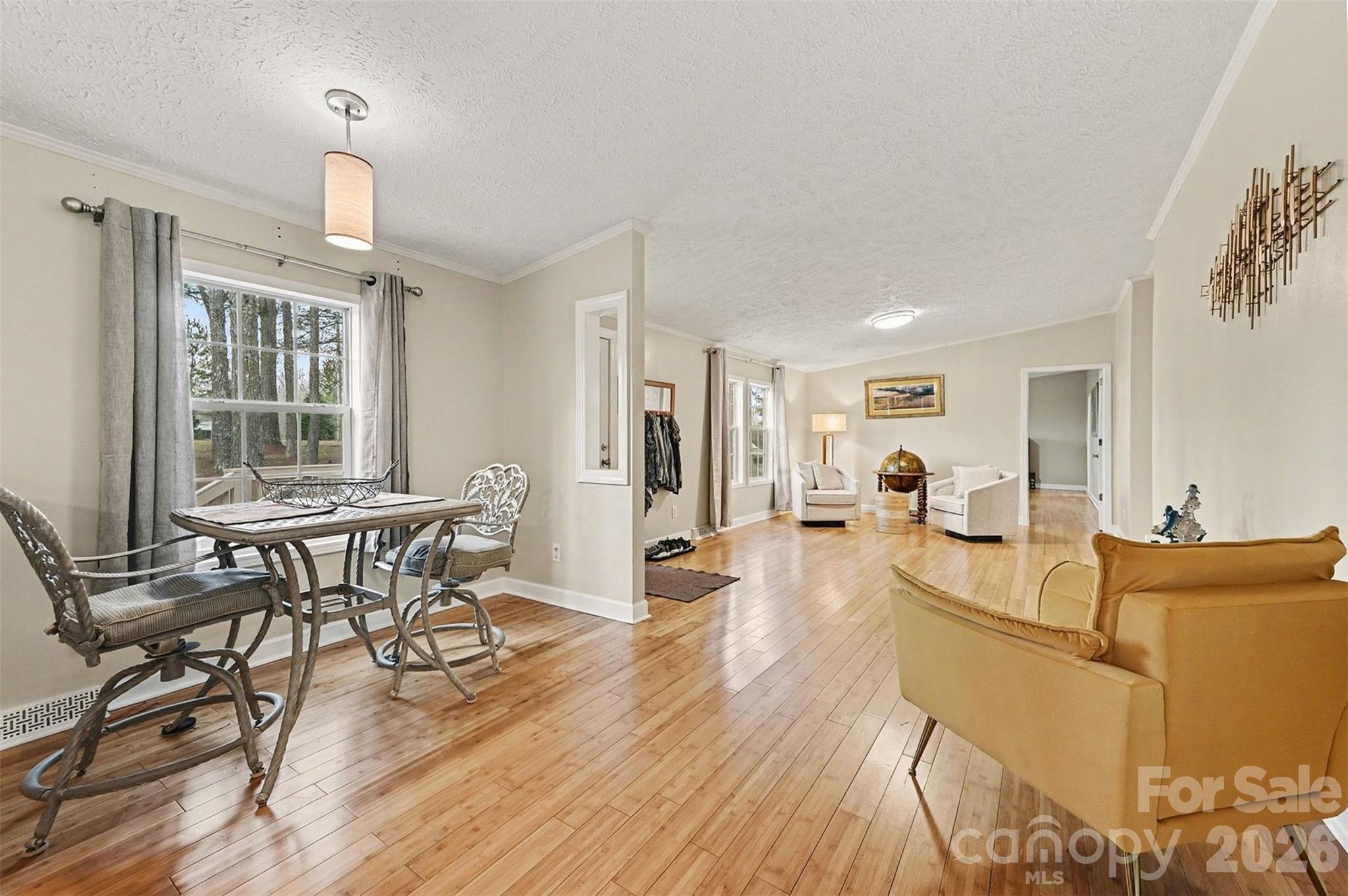 5018 Duncan Road Monroe, NC 28110 - Photo 11 of 33 a living room with furniture a dining table and a wooden floor