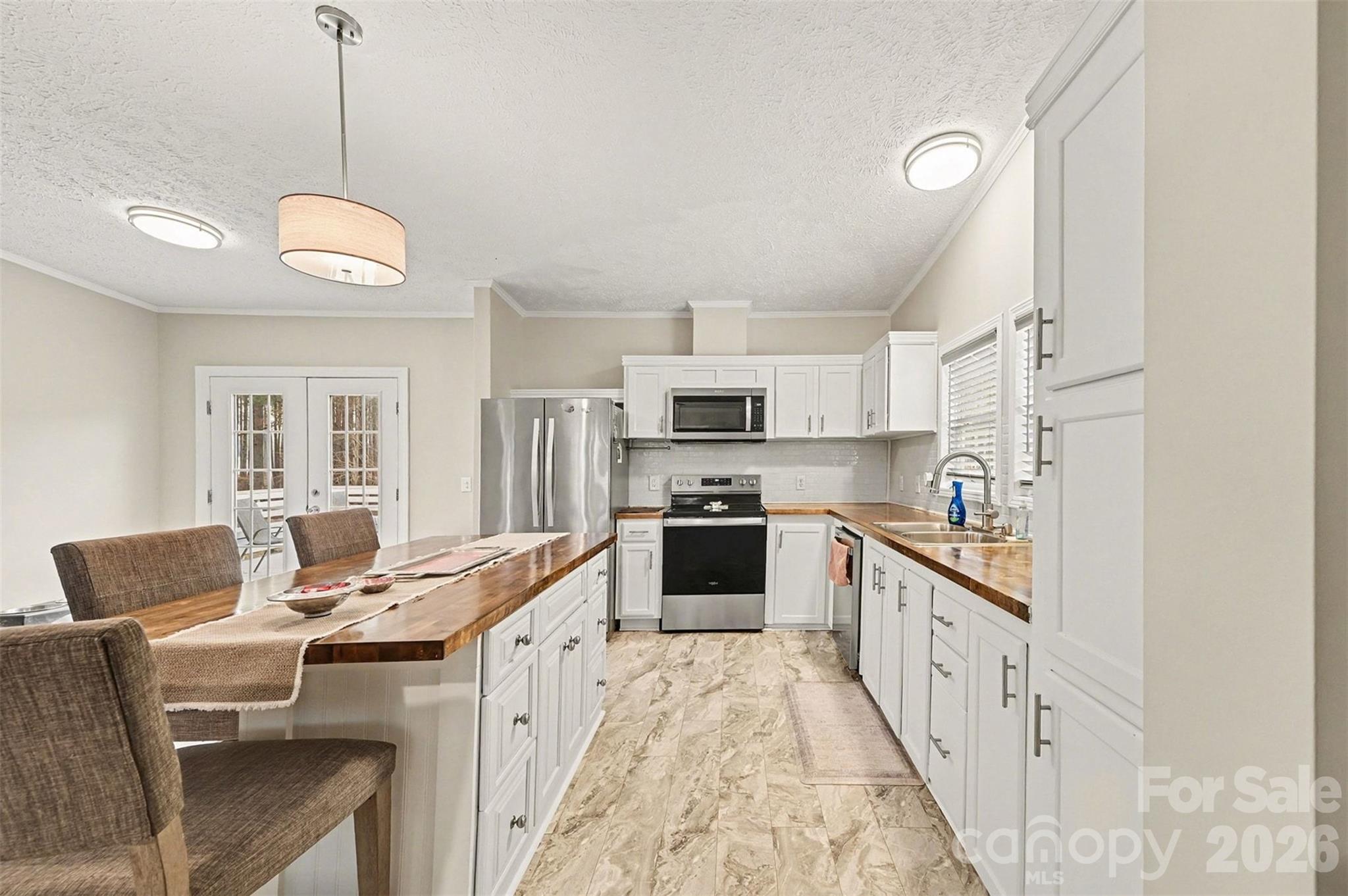 5018 Duncan Road Monroe, NC 28110 - Photo 14 of 33 a kitchen with stainless steel appliances granite countertop a stove top oven a sink dishwasher and a refrigerator with wooden floor