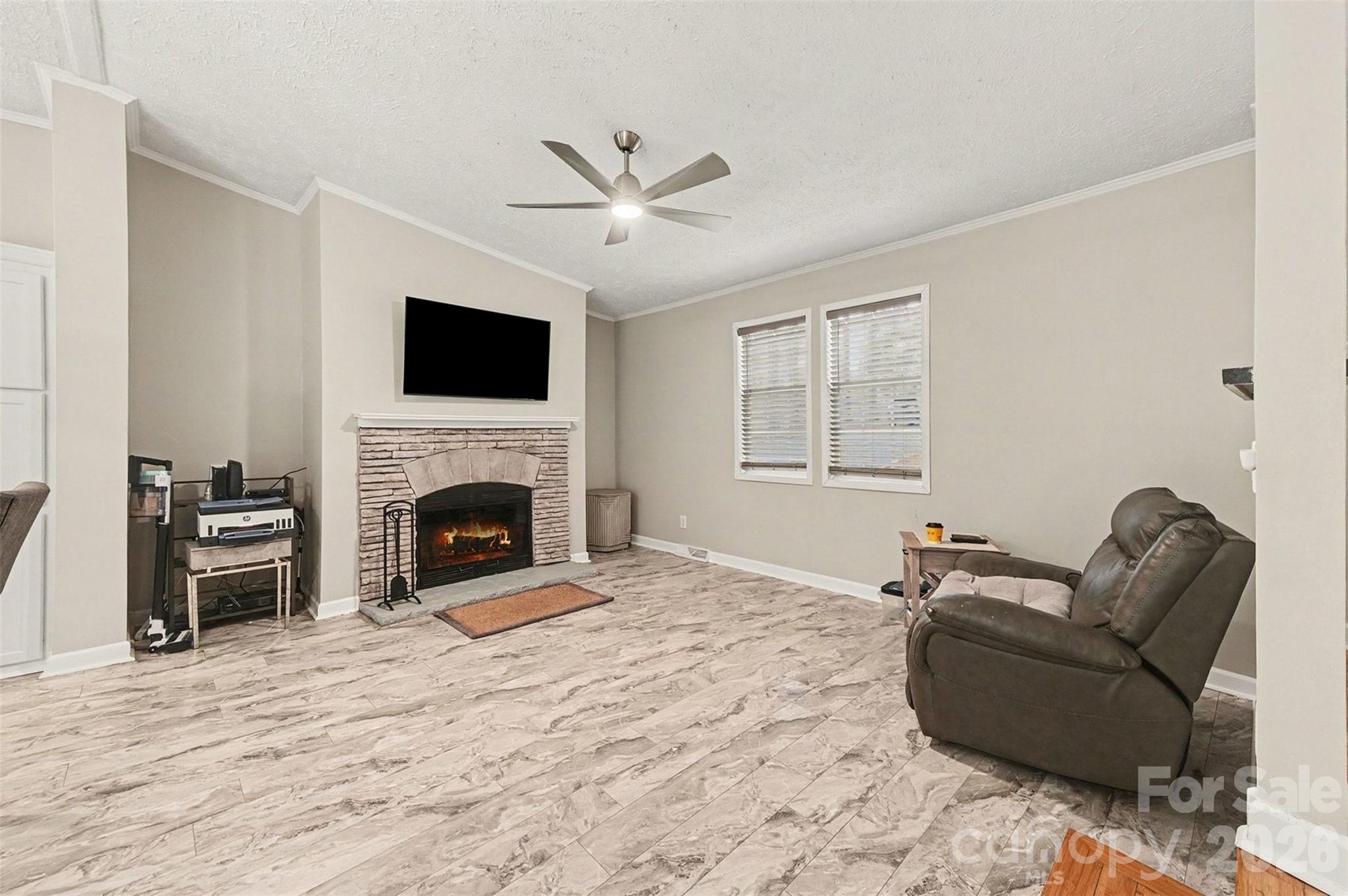 5018 Duncan Road Monroe, NC 28110 - Photo 16 of 33 a living room with furniture a flat screen tv and a fireplace