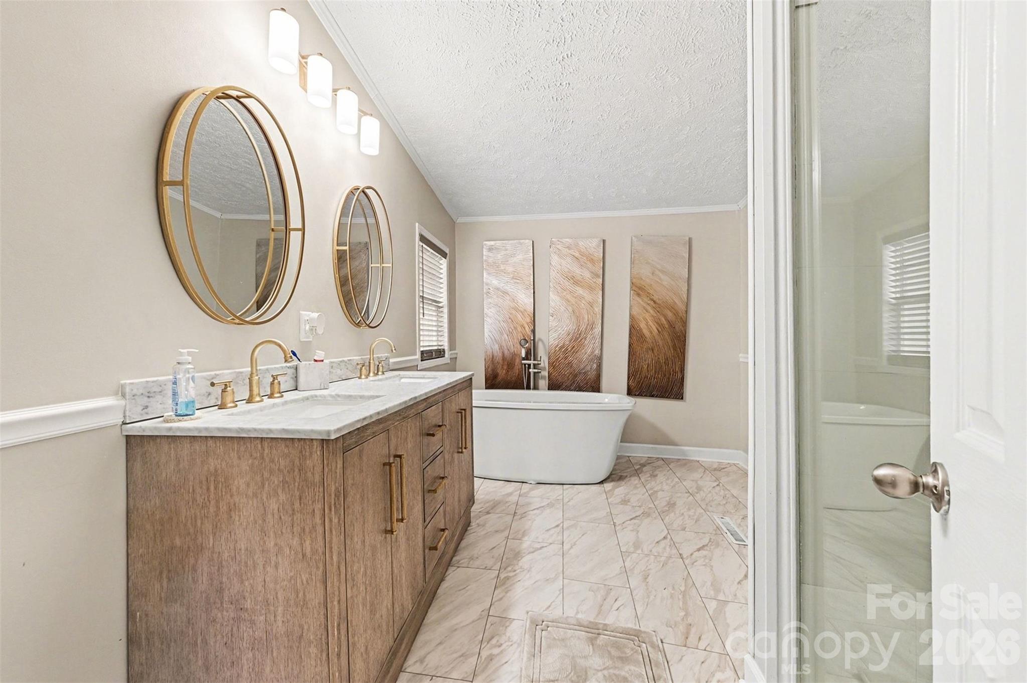5018 Duncan Road Monroe, NC 28110 - Photo 22 of 33 a bathroom with a granite countertop sink a mirror and a bathtub