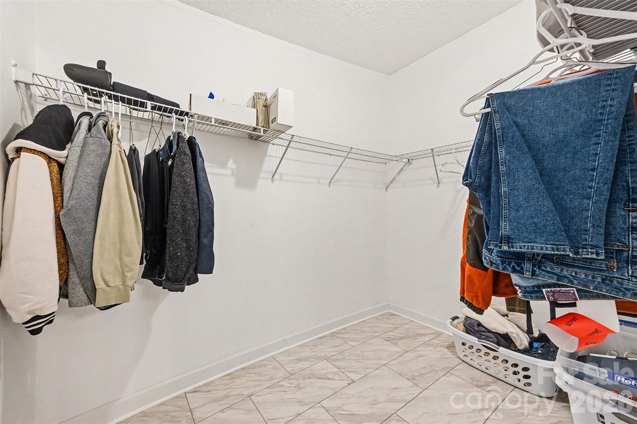 5018 Duncan Road Monroe, NC 28110 - Photo 24 of 33 a view of walk in closet with clothes and shoes